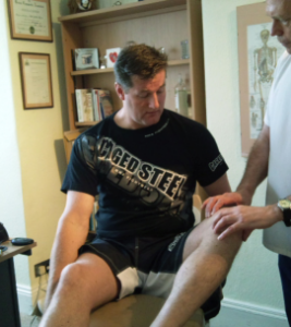 Knee-injury-treatment A Cage fighter being examined by Plymouth Chiropractor Kevin Kelly